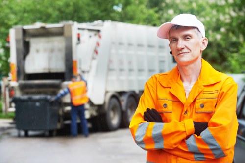 Construction site with builders managing waste clearance